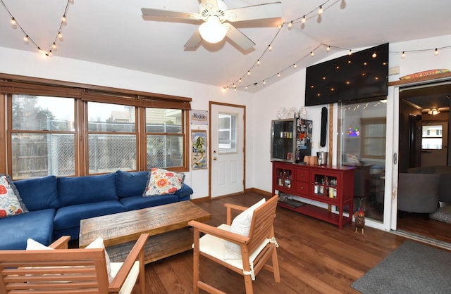 living room featuring lofted ceiling, wood finished floors, a ceiling fan, and rail lighting