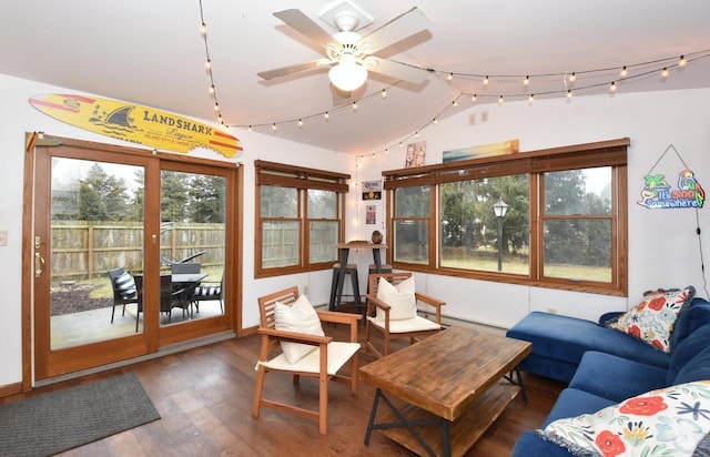 sunroom featuring vaulted ceiling, rail lighting, and a ceiling fan