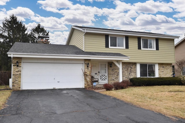 traditional home featuring driveway, a shingled roof, an attached garage, a front lawn, and brick siding