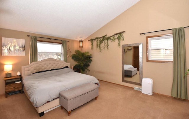 bedroom with vaulted ceiling, light carpet, visible vents, and baseboards