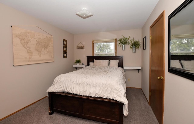 bedroom featuring carpet floors and baseboards