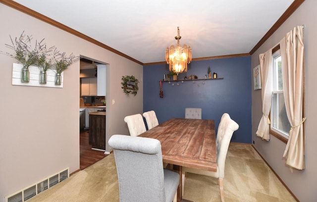 dining area featuring crown molding, carpet floors, visible vents, and a notable chandelier