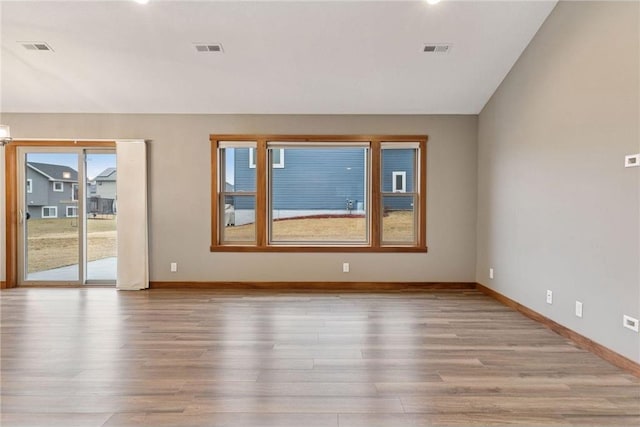 497 Westwood Dr, River Falls, WI 54022 - empty room featuring visible vents, baseboards, and wood finished floors