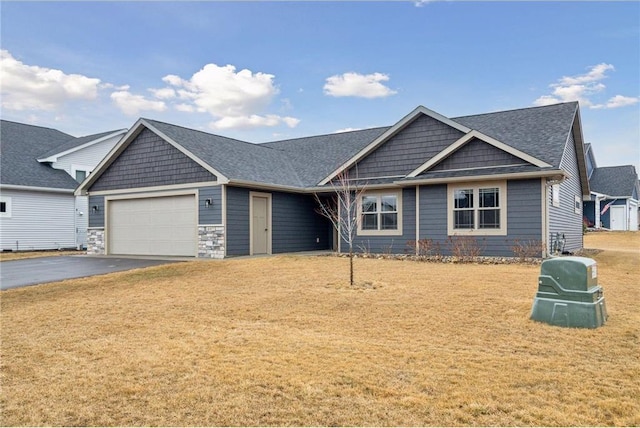 497 Westwood Dr, River Falls, WI 54022 - view of front of home featuring aphalt driveway, a garage, a shingled roof, stone siding, and a front yard