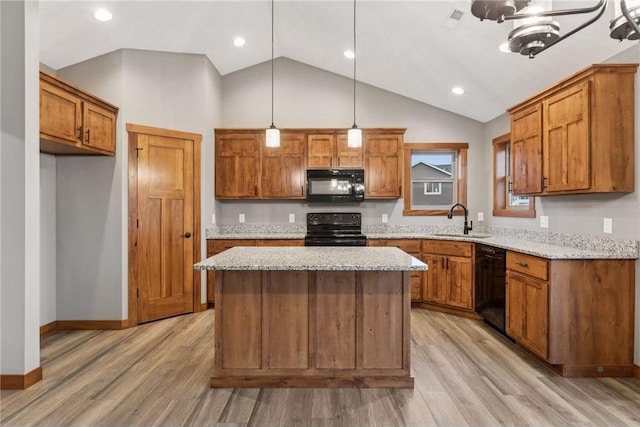 497 Westwood Dr, River Falls, WI 54022 - kitchen featuring black appliances, brown cabinetry, a sink, and light wood finished floors