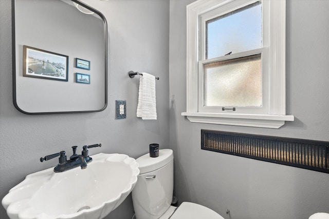 bathroom with toilet and a sink