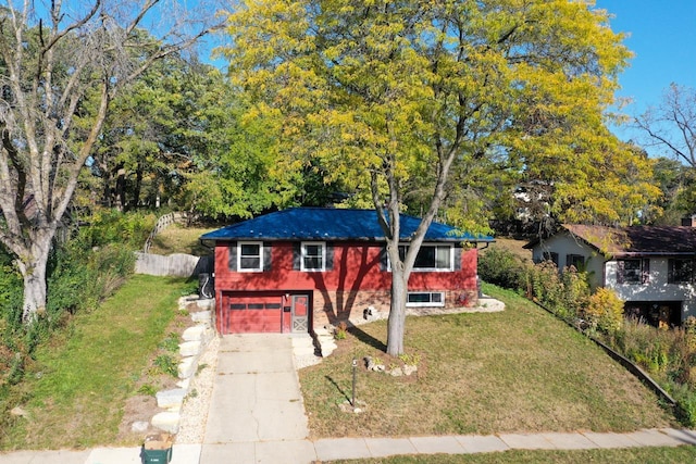 view of front of home with an attached garage, concrete driveway, brick siding, and a front yard