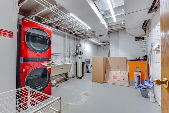 unfinished basement with stacked washer and dryer and a sink