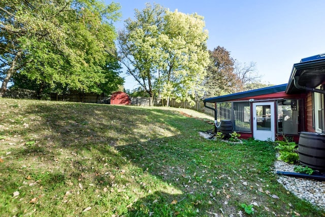 view of yard with a sunroom and fence