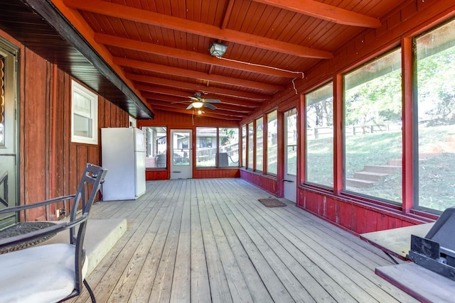 unfurnished sunroom with lofted ceiling with beams and a ceiling fan