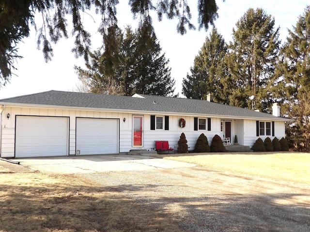 ranch-style house with driveway, board and batten siding, and an attached garage