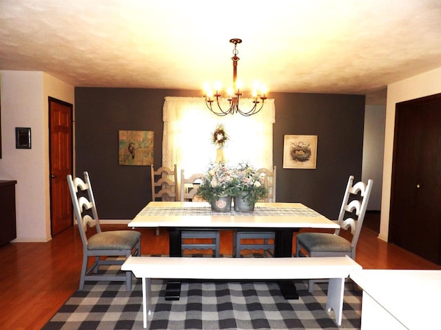 dining room featuring dark wood finished floors and a notable chandelier