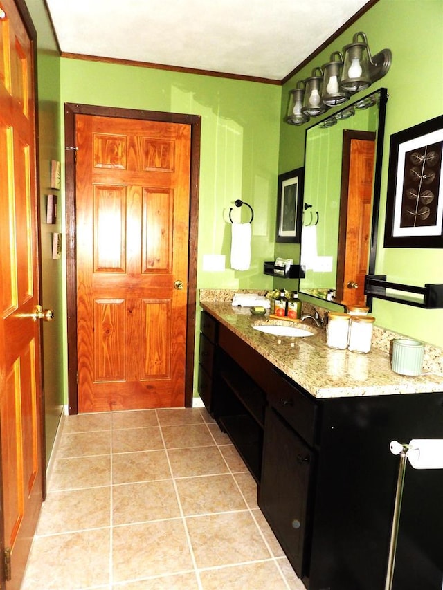 bathroom with tile patterned flooring, crown molding, and vanity