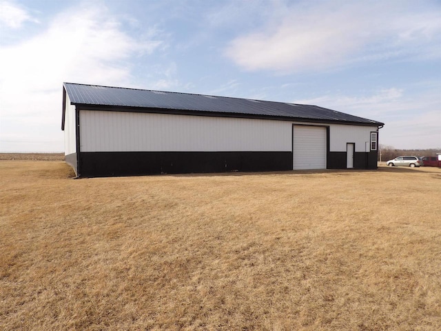 view of pole building with a yard