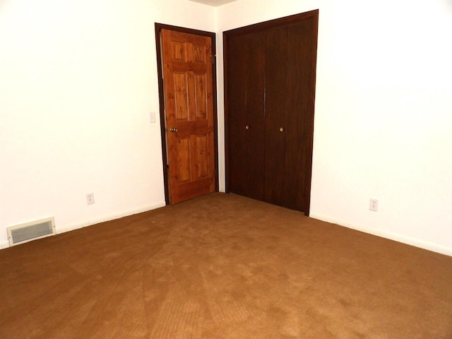 empty room with carpet floors and visible vents