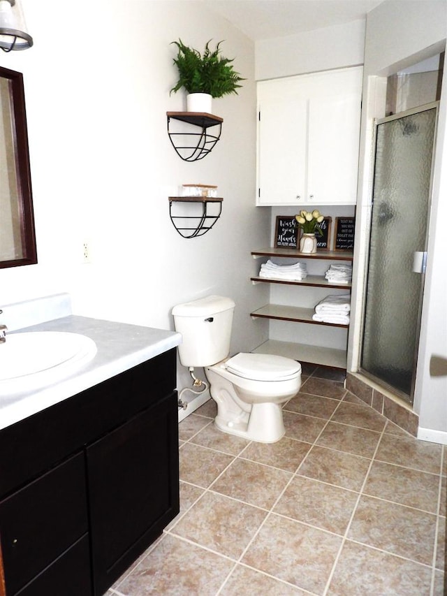 full bathroom with toilet, tile patterned flooring, a shower stall, and vanity