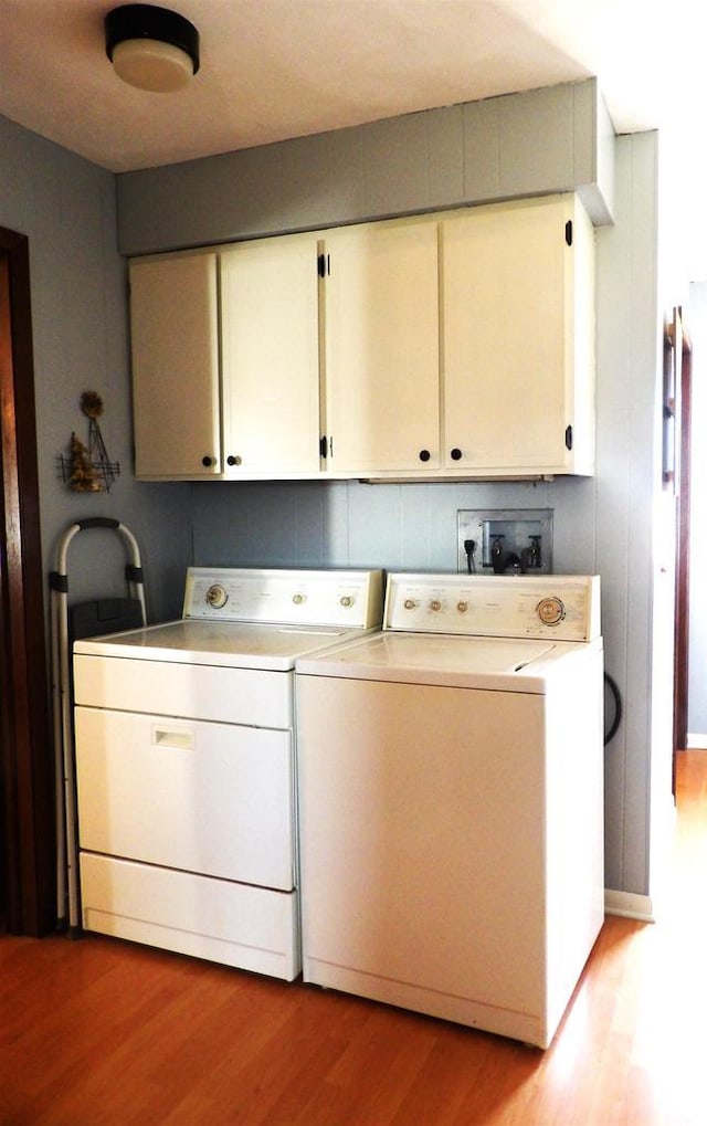 kitchen featuring light wood-style floors, white cabinetry, light countertops, and independent washer and dryer