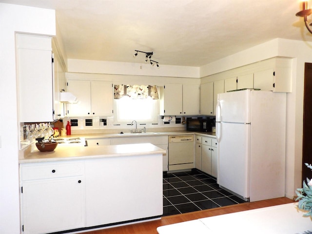 kitchen featuring white appliances, a peninsula, extractor fan, light countertops, and a sink