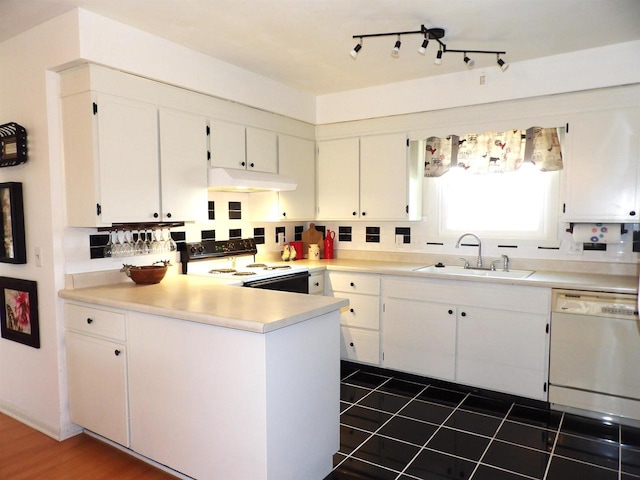 kitchen featuring electric range oven, white cabinetry, a sink, white dishwasher, and under cabinet range hood