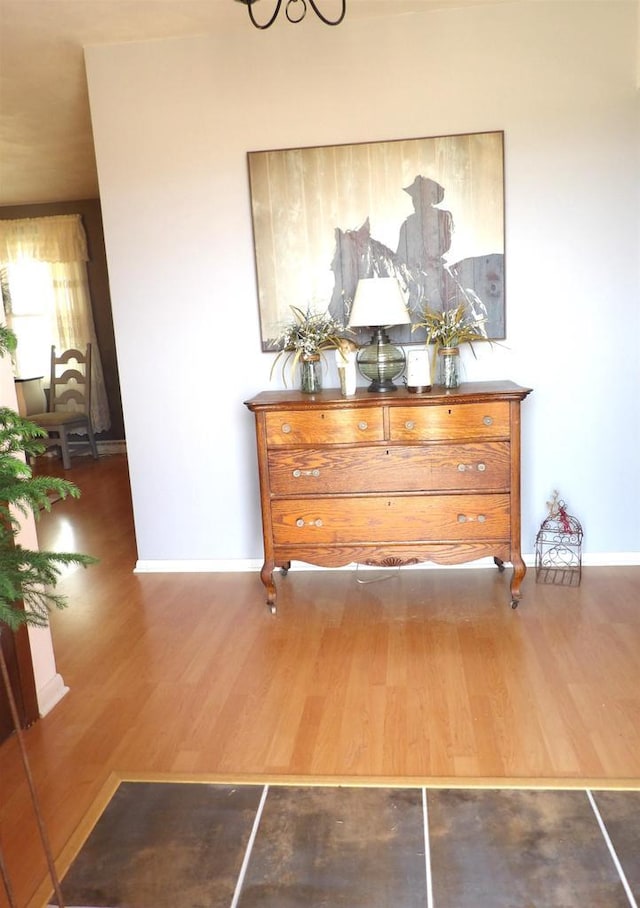 interior space with wood finished floors and baseboards