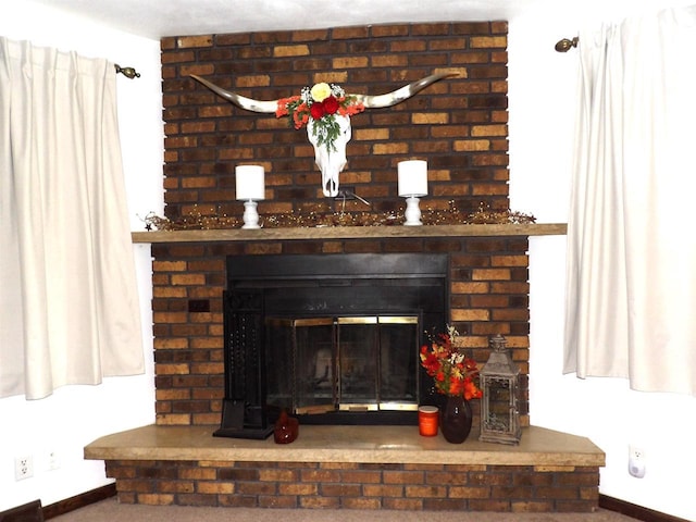 room details with a brick fireplace and baseboards