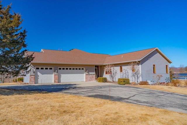 single story home with a garage and driveway