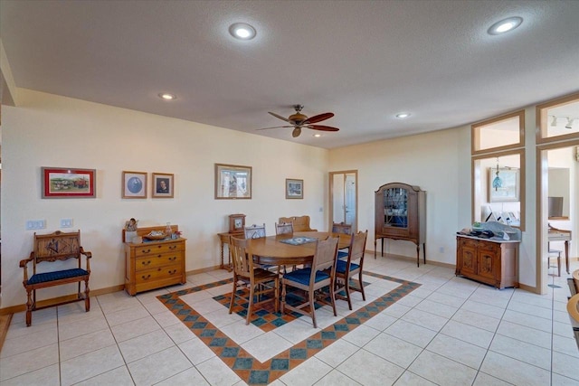 dining space featuring light tile patterned floors, recessed lighting, a textured ceiling, and baseboards