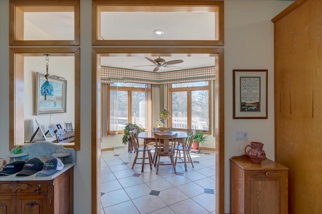 dining space with light tile patterned flooring and ceiling fan