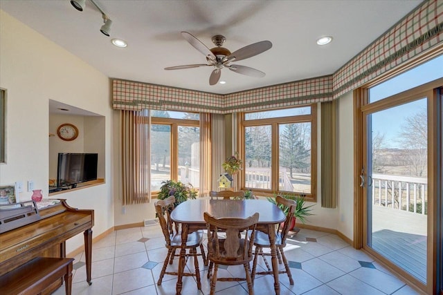 dining space with light tile patterned floors, track lighting, a ceiling fan, and baseboards