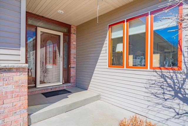 doorway to property with brick siding