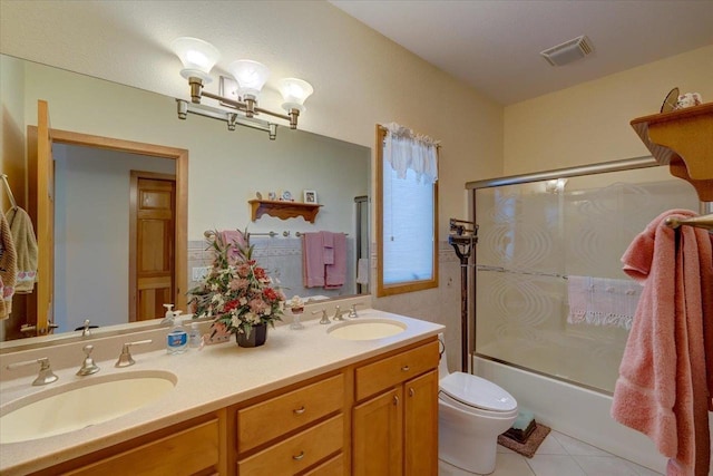 bathroom with tile patterned flooring, visible vents, toilet, and a sink