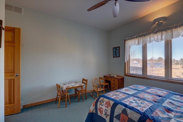 carpeted bedroom with visible vents, baseboards, and ceiling fan