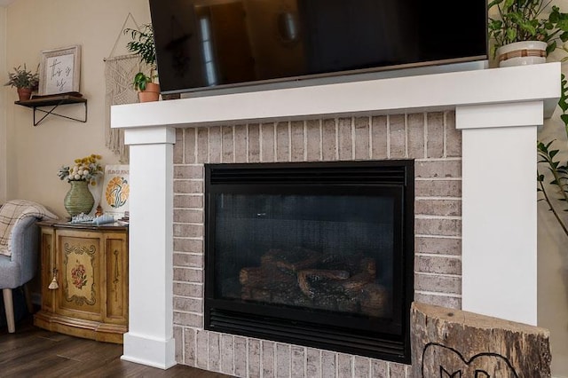 room details with a fireplace and wood finished floors