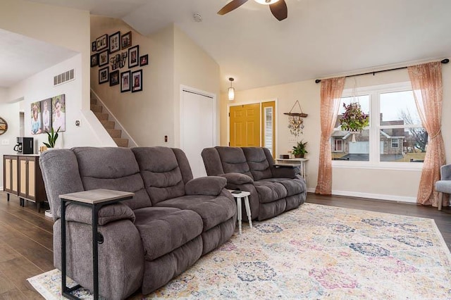 living area with lofted ceiling, stairway, wood finished floors, and visible vents