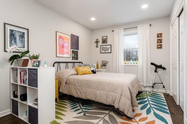 bedroom with recessed lighting, a closet, dark wood finished floors, and baseboards