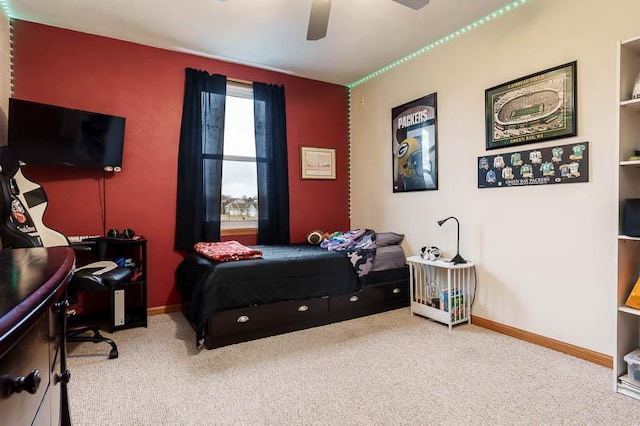 bedroom with a ceiling fan, carpet flooring, and baseboards