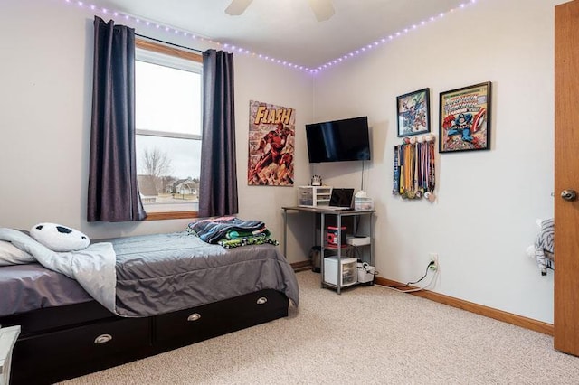 carpeted bedroom featuring a ceiling fan and baseboards