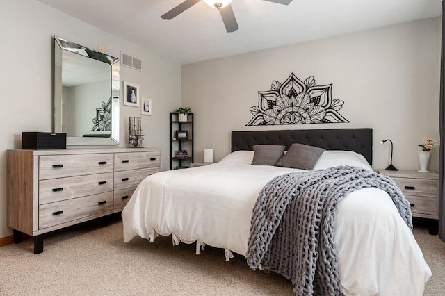 carpeted bedroom featuring visible vents and a ceiling fan