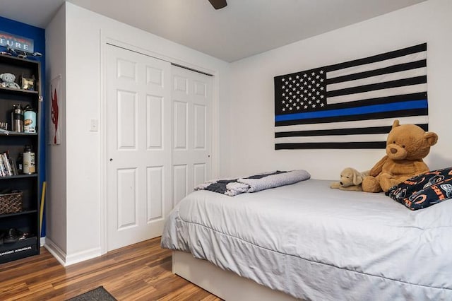 bedroom with a closet, a ceiling fan, and wood finished floors