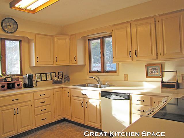 872 Northside Dr, Platteville, WI 53818 - kitchen featuring a healthy amount of sunlight, light countertops, white dishwasher, and a sink