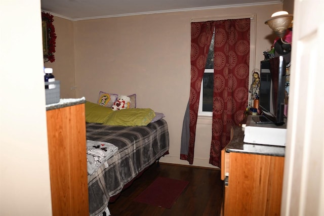 bedroom with wood finished floors and crown molding