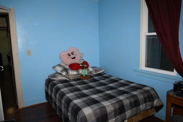 bedroom with dark wood-type flooring