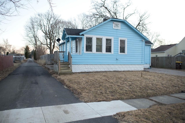 view of front facade featuring fence