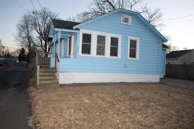 view of property exterior featuring fence