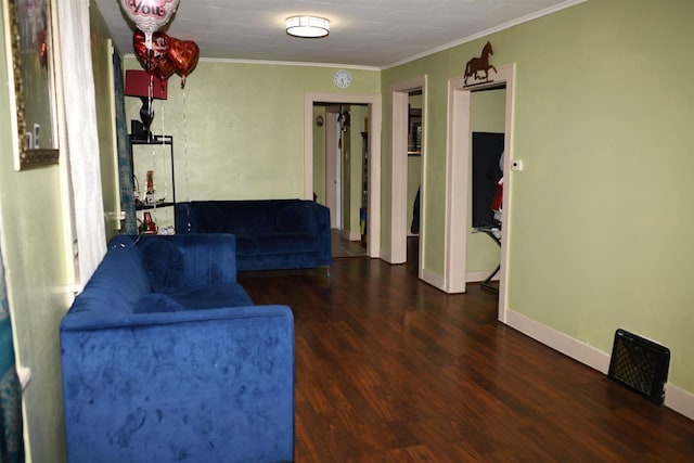 interior space with baseboards, wood finished floors, and crown molding