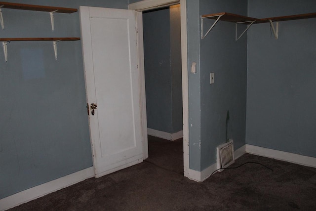 unfurnished bedroom with carpet floors, visible vents, and baseboards