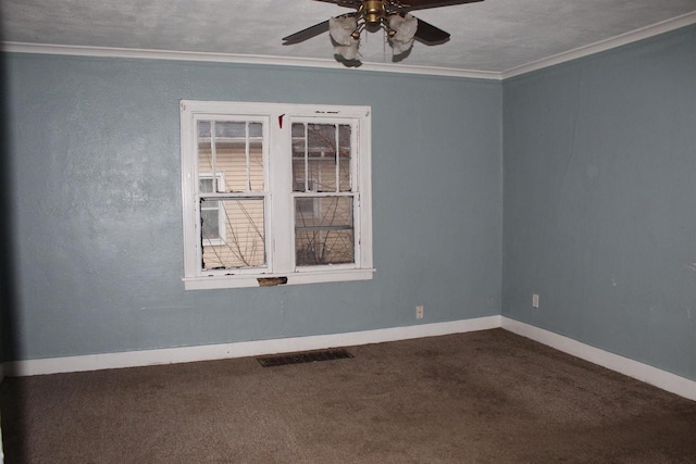 carpeted empty room featuring baseboards, visible vents, ceiling fan, and crown molding