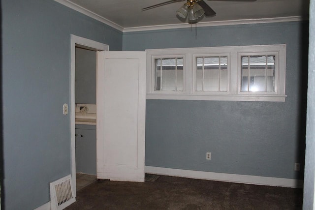 unfurnished bedroom featuring ceiling fan, ornamental molding, visible vents, and baseboards