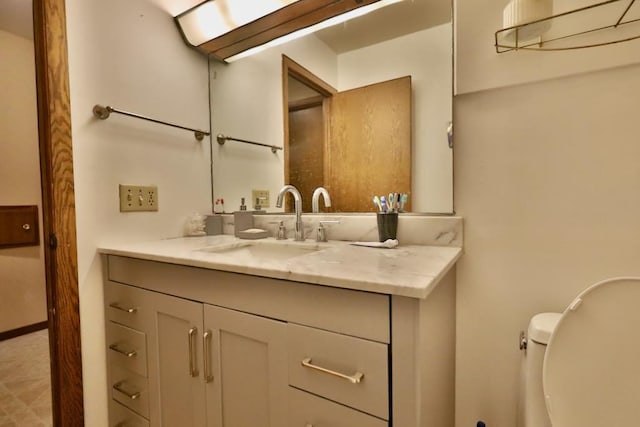 half bath featuring toilet and vanity