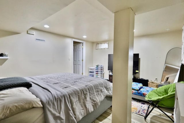 bedroom with light wood-style flooring, visible vents, and recessed lighting